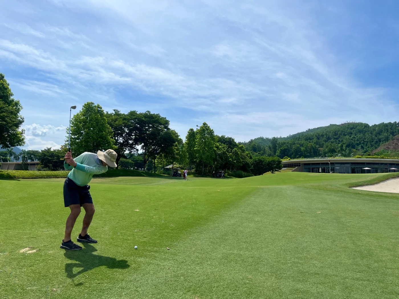 Matthew Carney playing an iron shot on an outdoor golf course